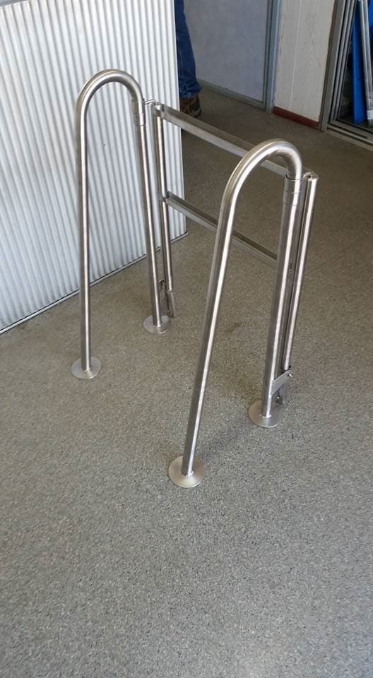 A Stainless Steel Railing Is Sitting on A Gray Carpeted Floor — K & S Sheetmetal in Gladstone Central, QLD