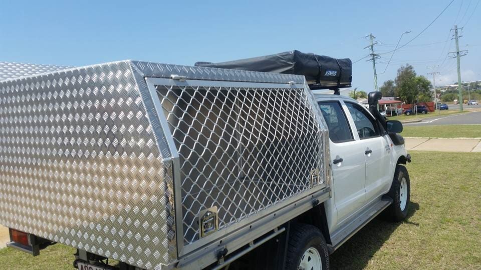 A White Truck with A Canopy on Top of It Is Parked in A Grassy Field — K & S Sheetmetal in Gladstone Central, QLD
