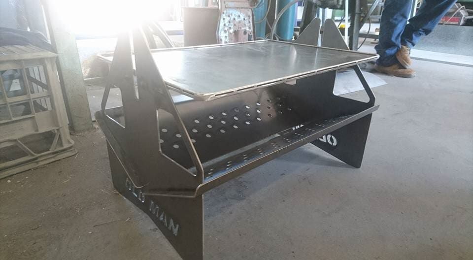 A Person Is Standing Next to A Metal Table in A Room — K & S Sheetmetal in Gladstone Central, QLD