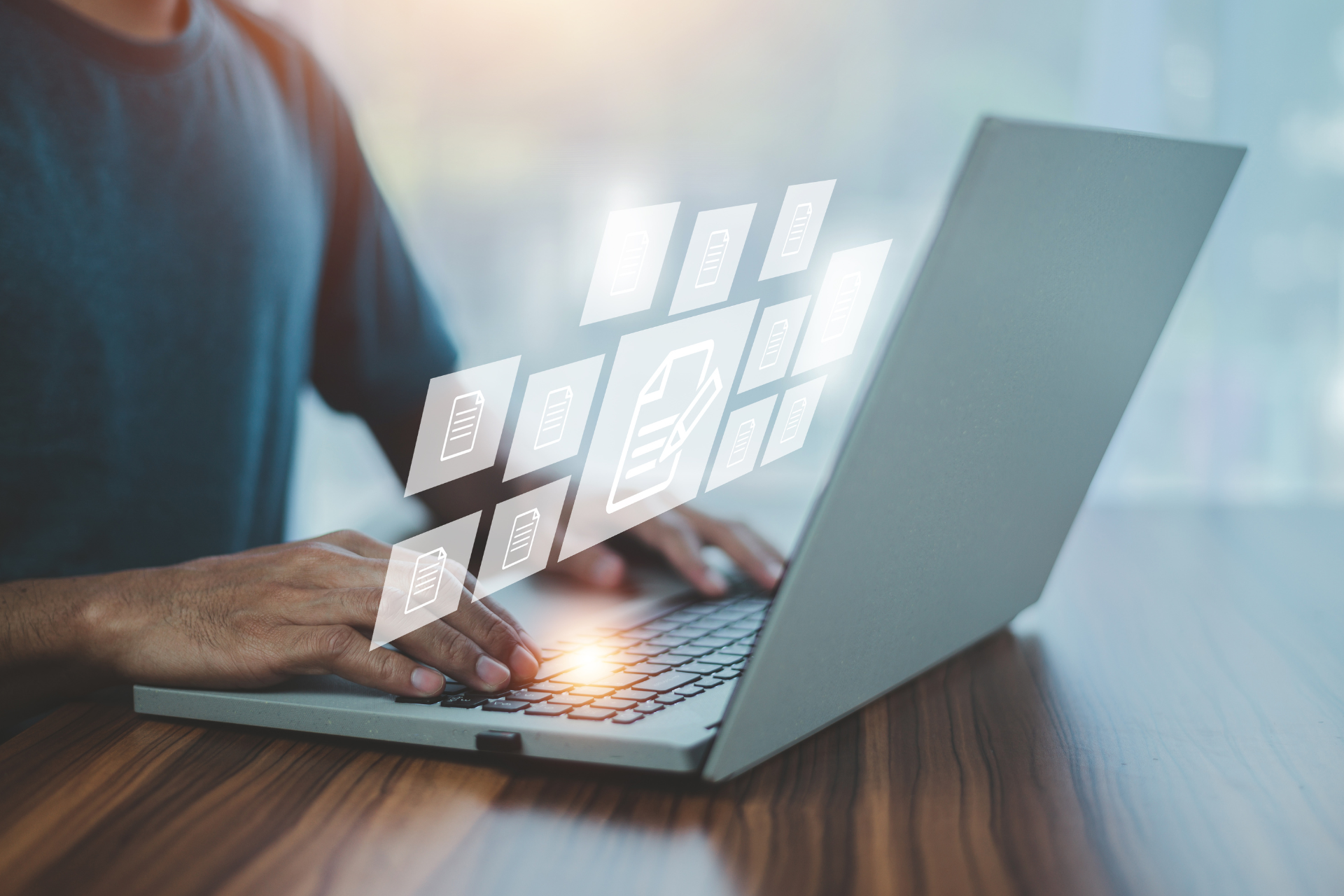 Person typing on a laptop with glowing digital interface icons floating above the keyboard
