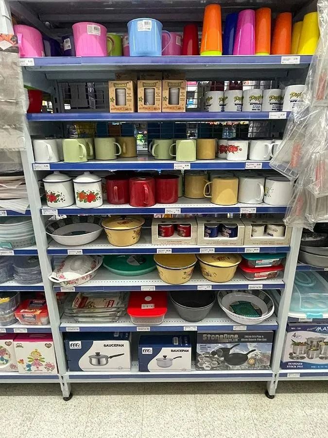 Shelves in a Store Filled With Colourful Mugs, Bowls — Pigglys Supermarket, Takeaway & Bottle Shop in The Gap, NT