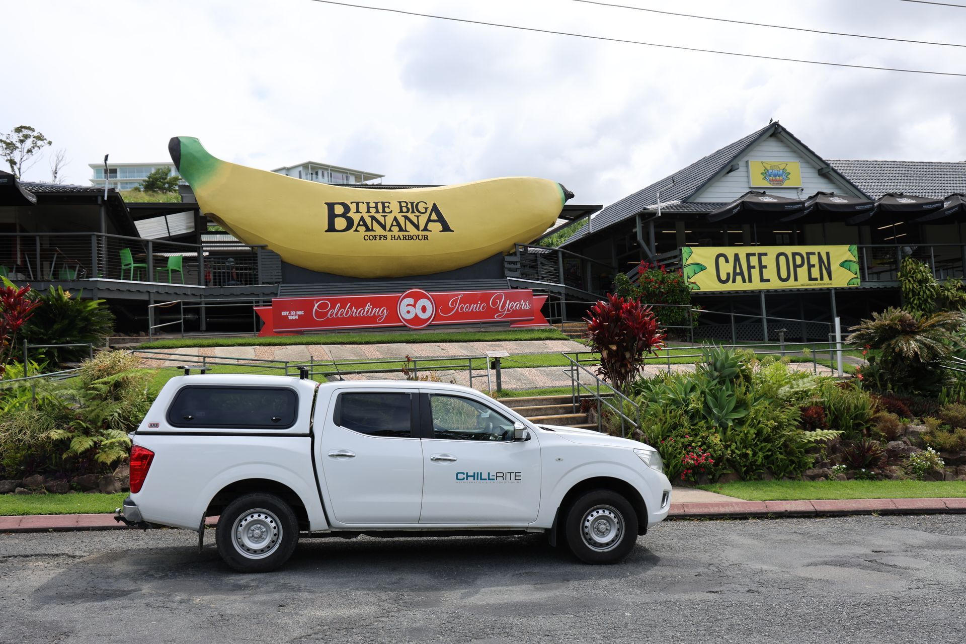White pickup truck parked in front of The Big Banana, a roadside attraction in Australia with a cafe -Chill-Rite Refrigeration and Air Conditioning in Coffs Harbour, NSW