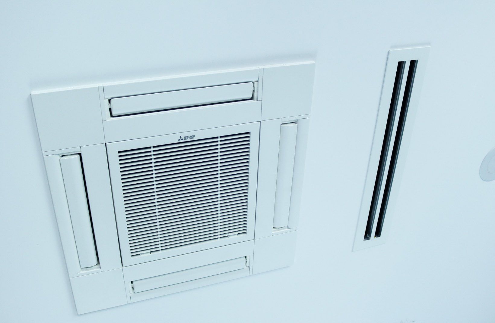 A White Air Conditioner is Mounted on a White Wall — Chill-Rite Refrigeration and Air Conditioning in Dubbo, NSW