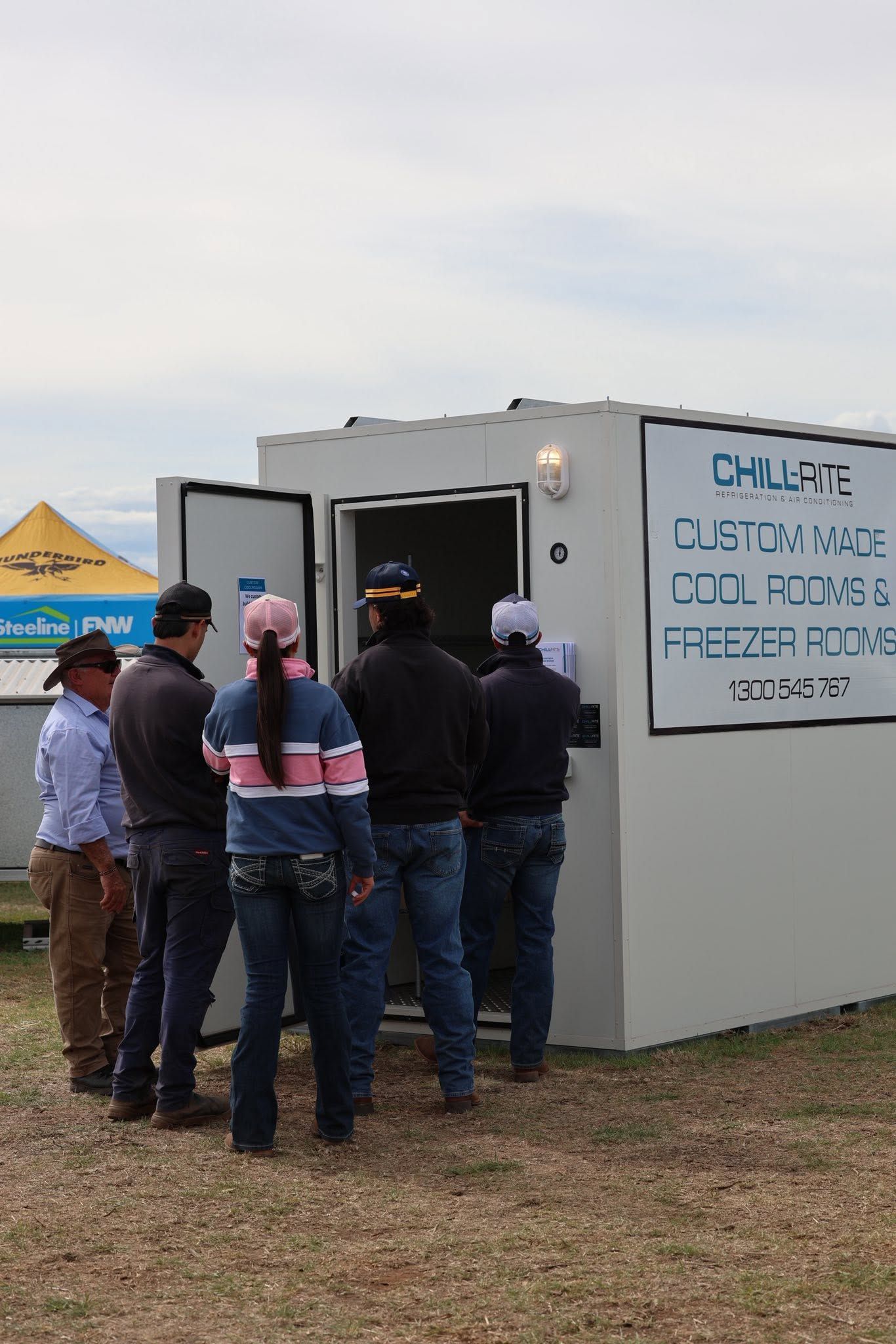 People Gathered Outside a Gray Portable Unit — Chill-Rite Refrigeration and Air Conditioning in Wagga Wagga, NSW
