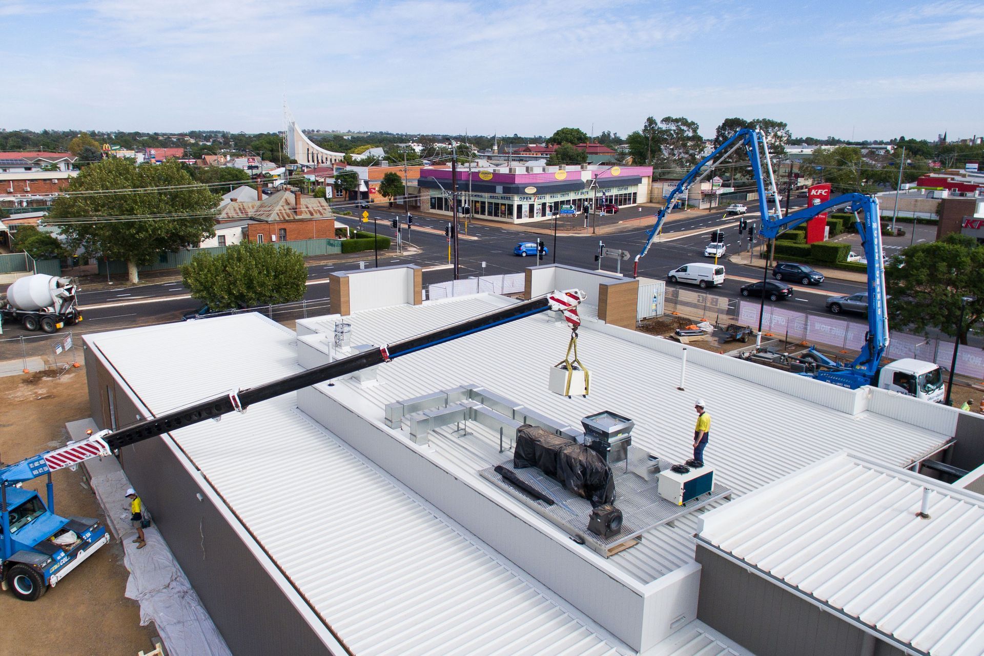 Workers on a Rooftop Using a Crane — Chill-Rite Refrigeration and Air Conditioning in Wagga Wagga, NSW