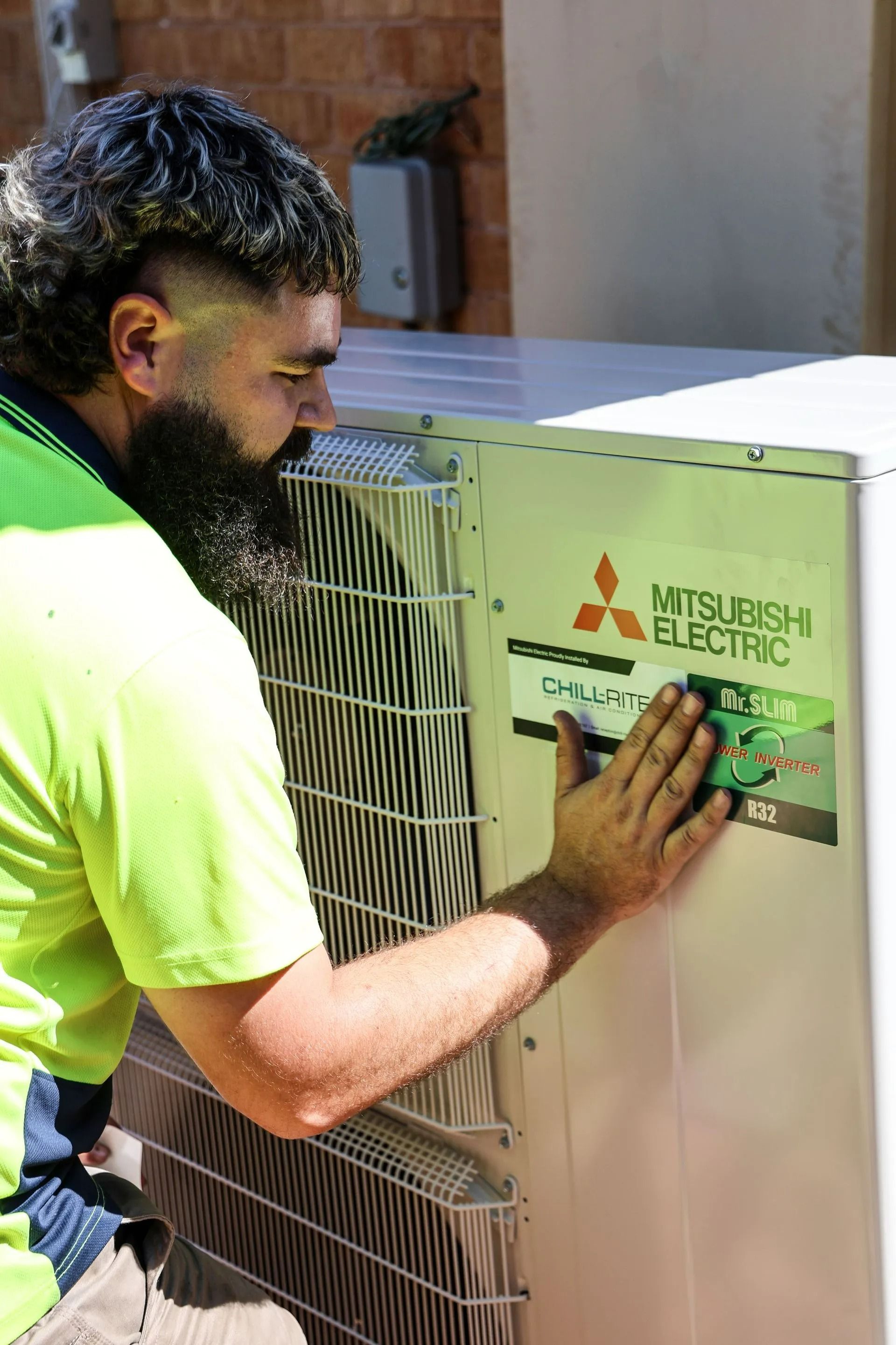 Technician Inspecting Air Conditioner In Newcastle