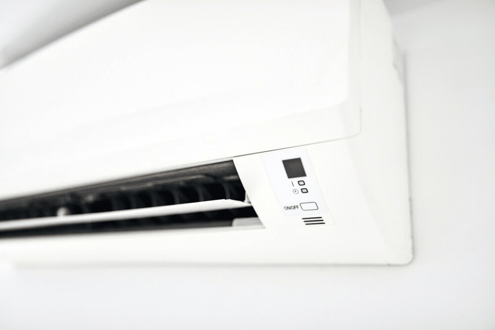 A White Air Conditioner is Hanging on a White Wall — Chill-Rite Refrigeration and Air Conditioning in Orange, NSW
