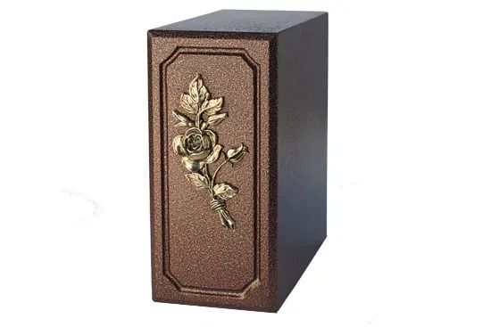 Decorative black box with a bronze floral ornament on the front panel