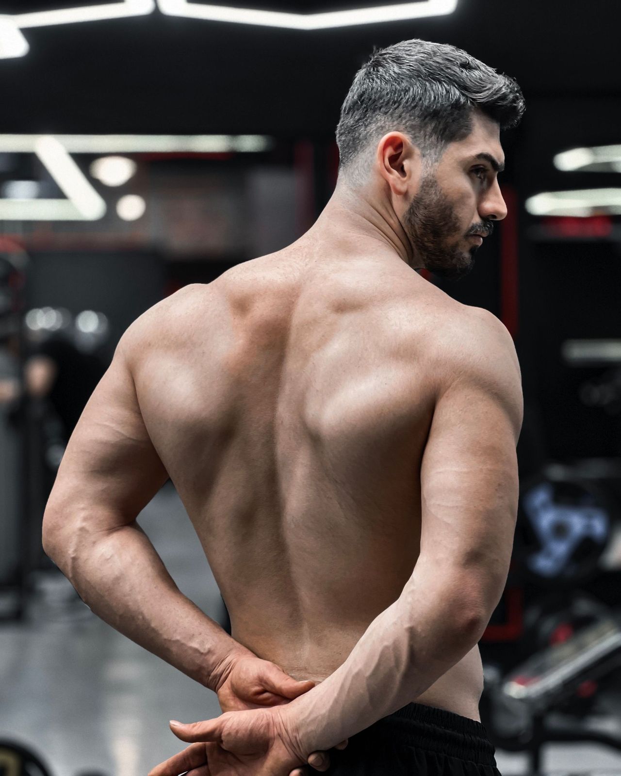 Man showing a smooth back and shoulders after a men's back and shoulder wax in Seattle