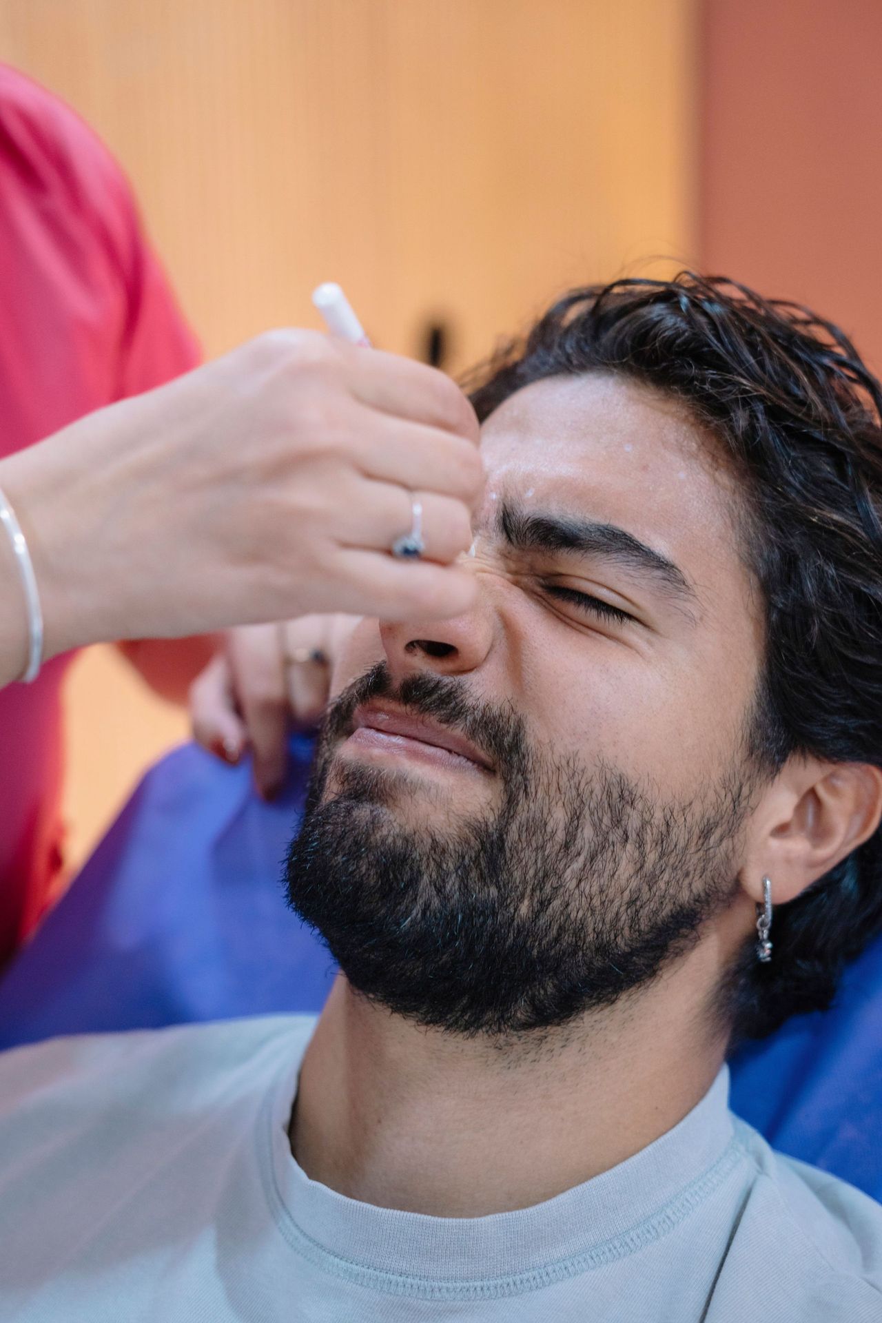 Man getting a nostril wax at a Seattle waxing studio