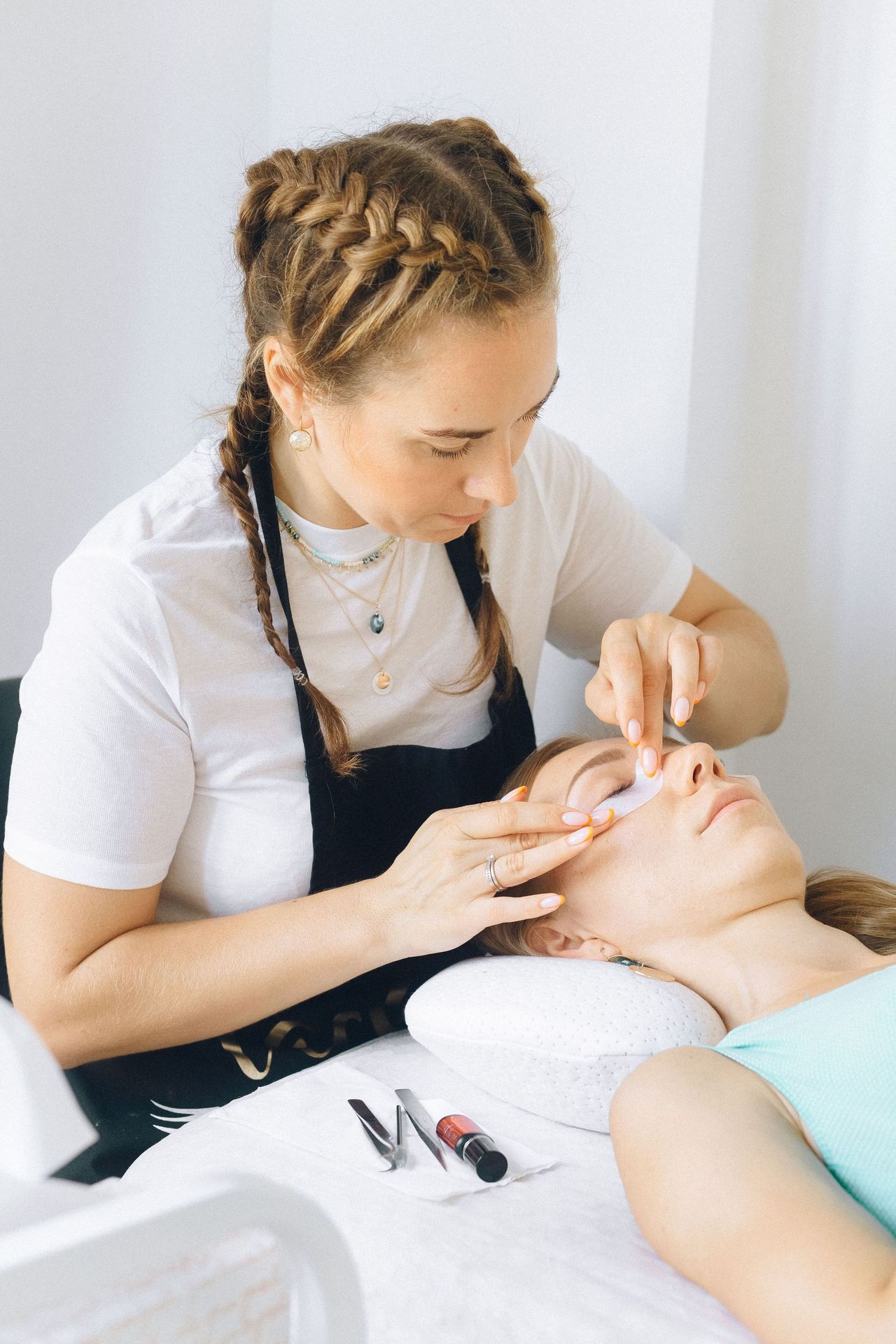 Licensed technician waxing a woman's brows at our Seattle waxing studio