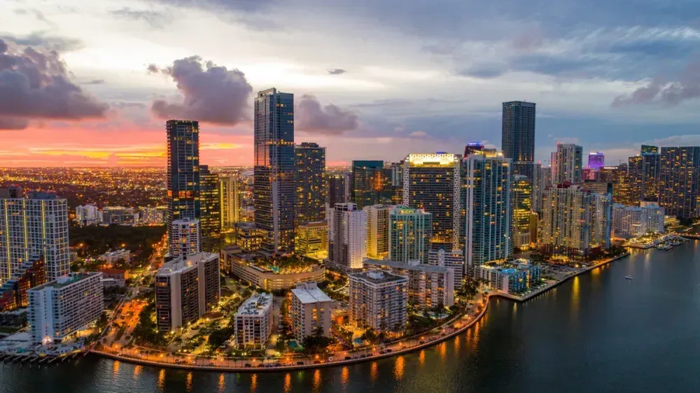 Sunset skyline of modern high-rises along a waterfront of Miami