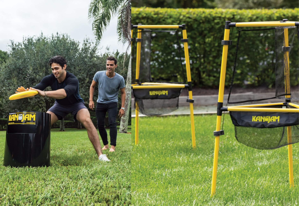 Two people training outdoors with yellow agility hurdles on a grassy field.