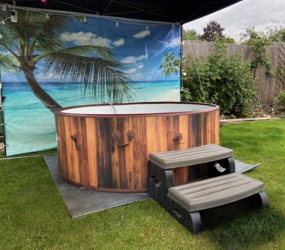 Backyard hot tub beside two-step stairs under a beach-themed canopy backdrop
