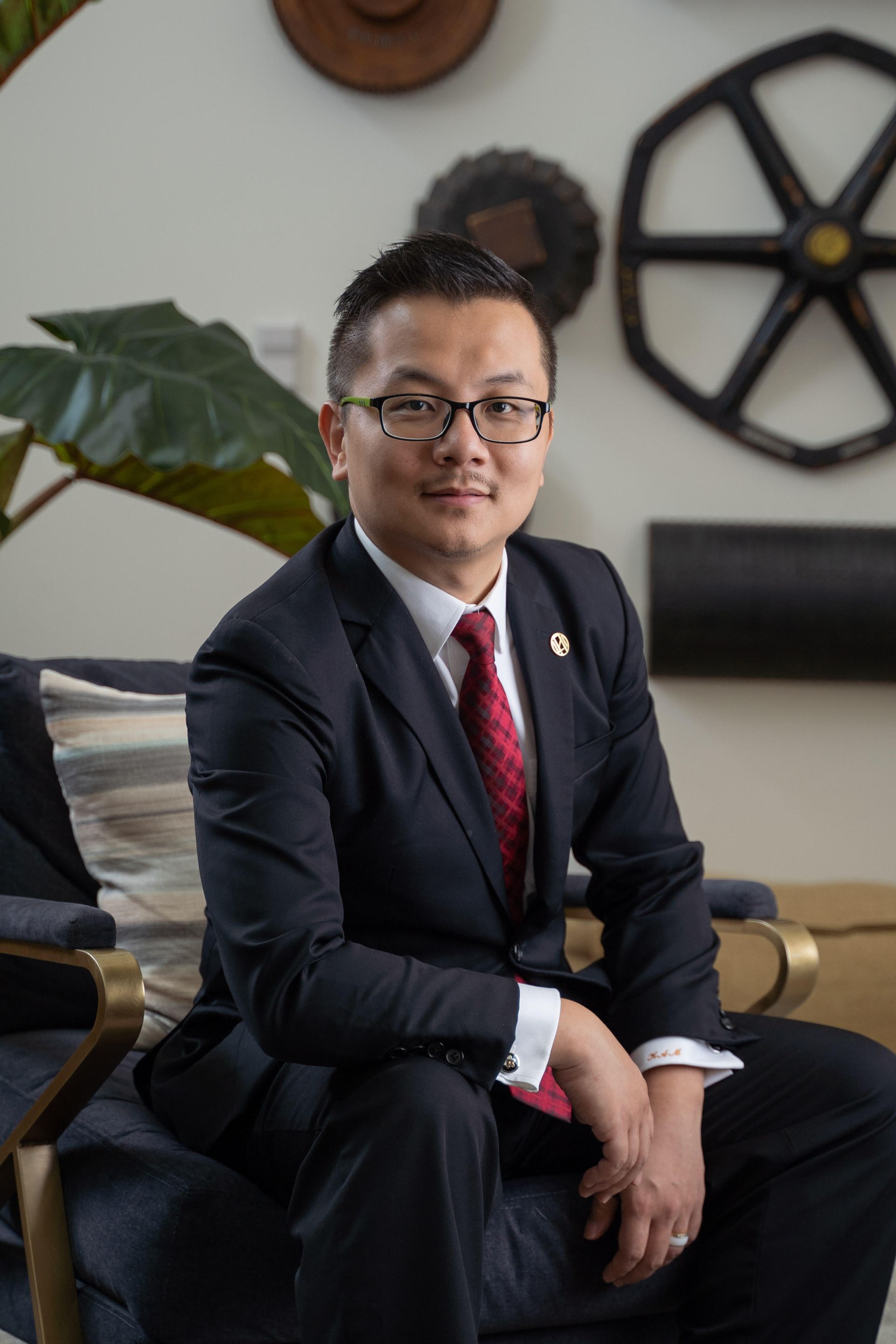 A man in a suit and tie is sitting in a chair.