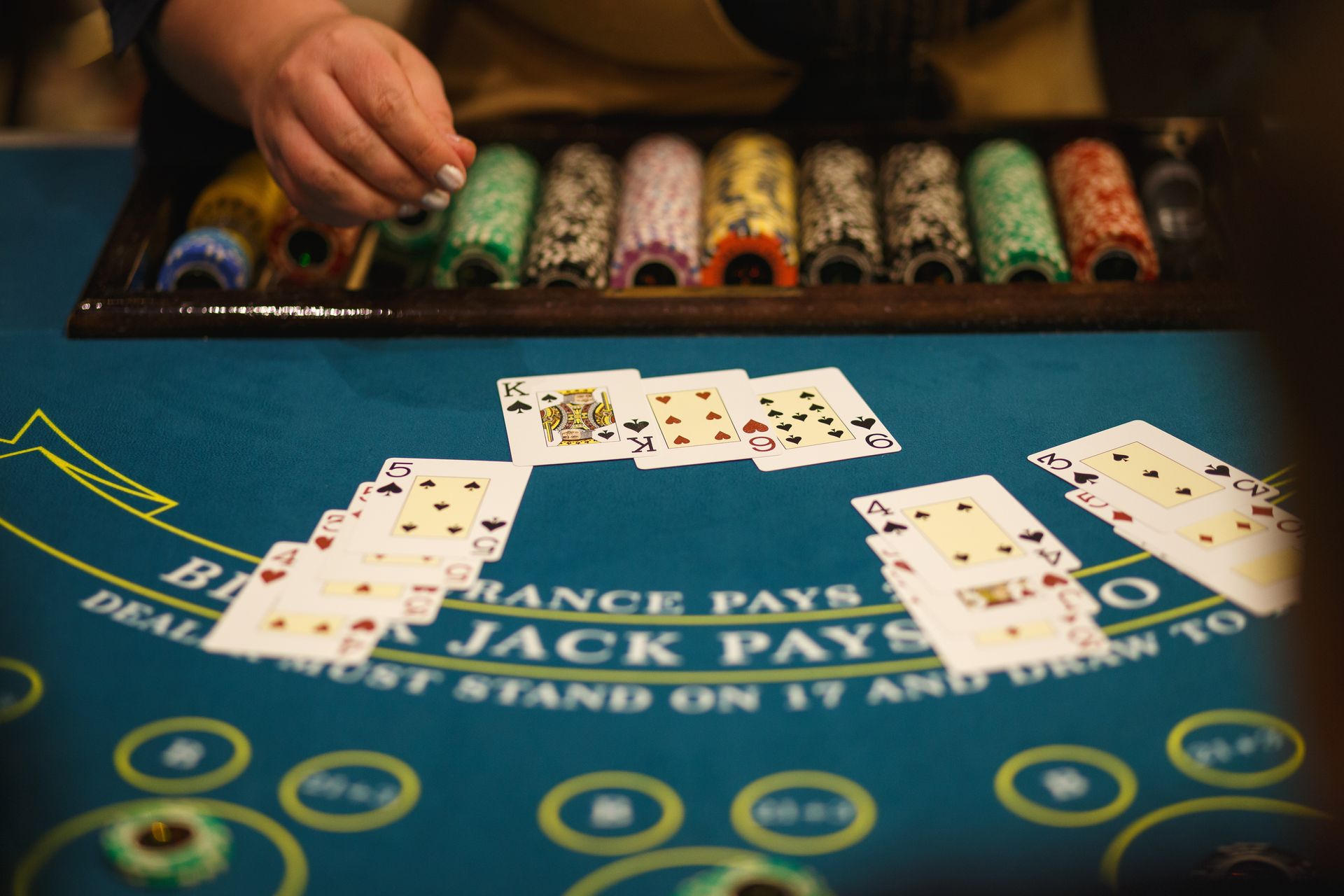 EZ baccarat table with cards and chips mid-deal during a live casino game