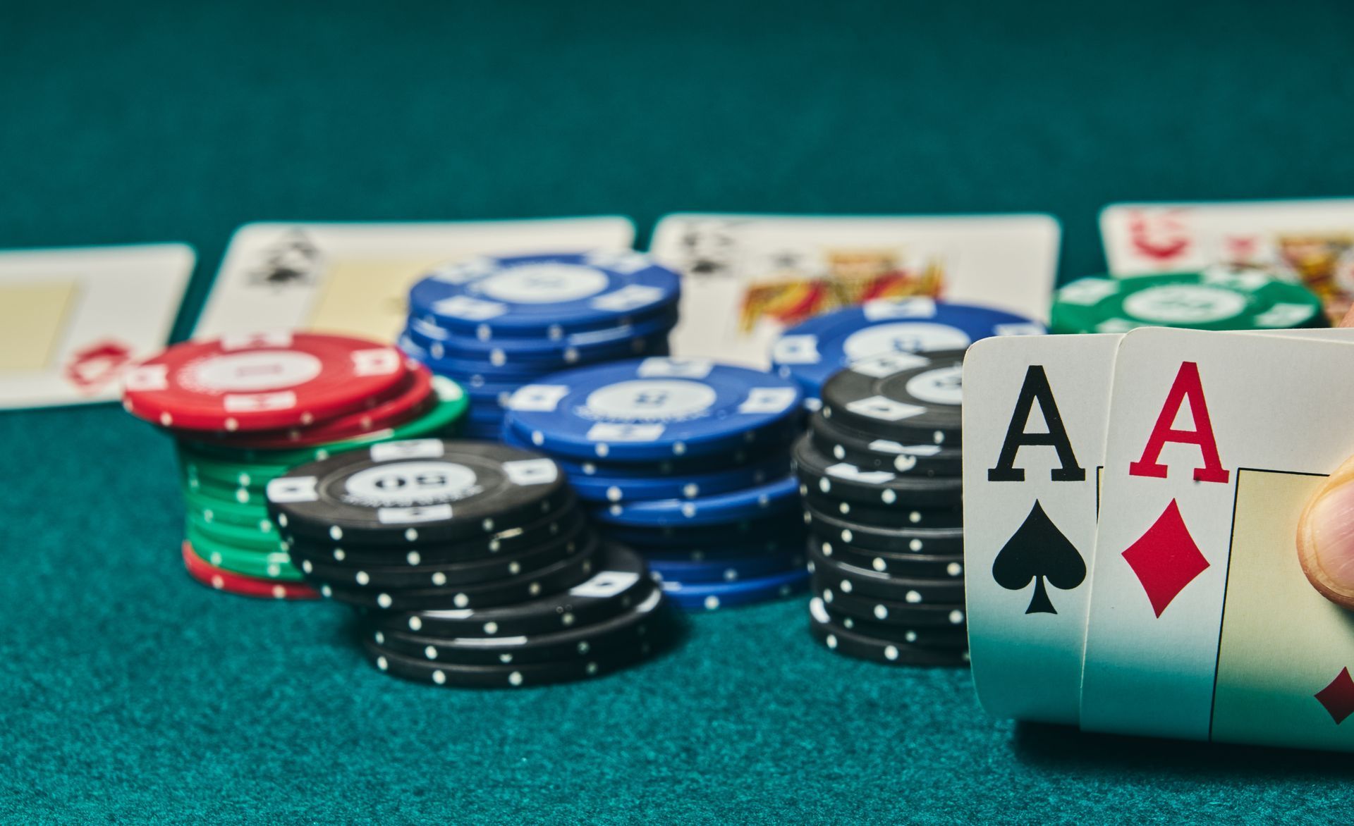 Texas hold'em poker room with players seated around a green felt card table