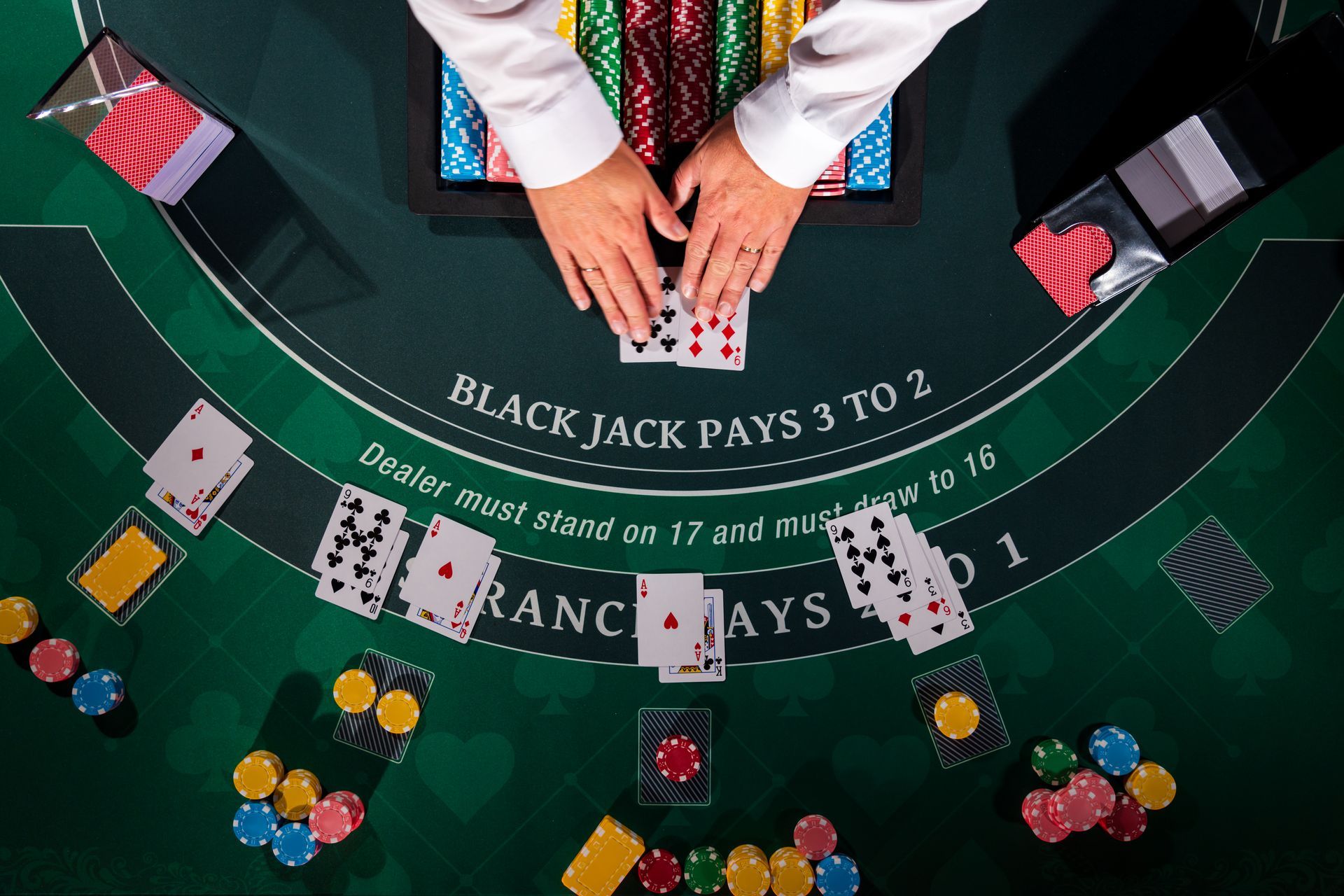 Overhead view of blackjack table showcasing live blackjack game action. Overhead view of blackjack table showcasing live blackjack game action.