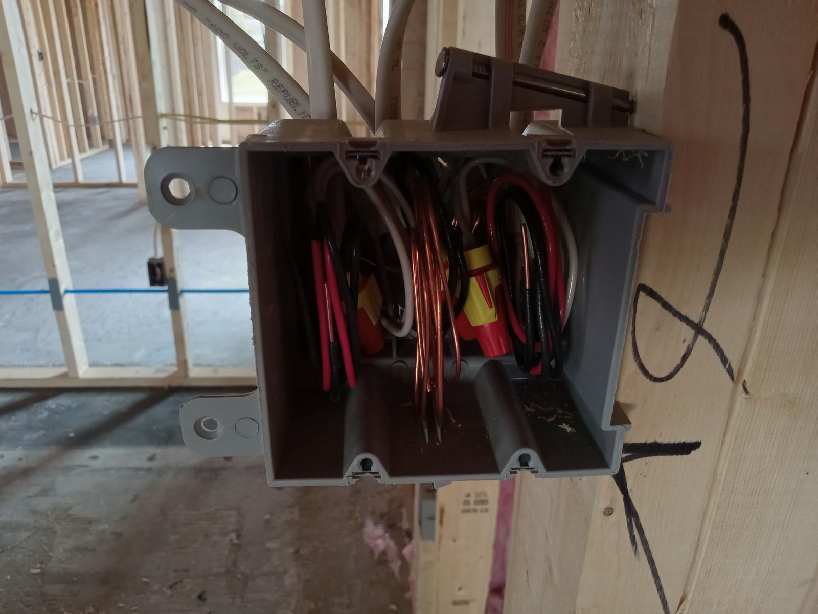 A close up of a electrical panel with a lot of wires coming out of it