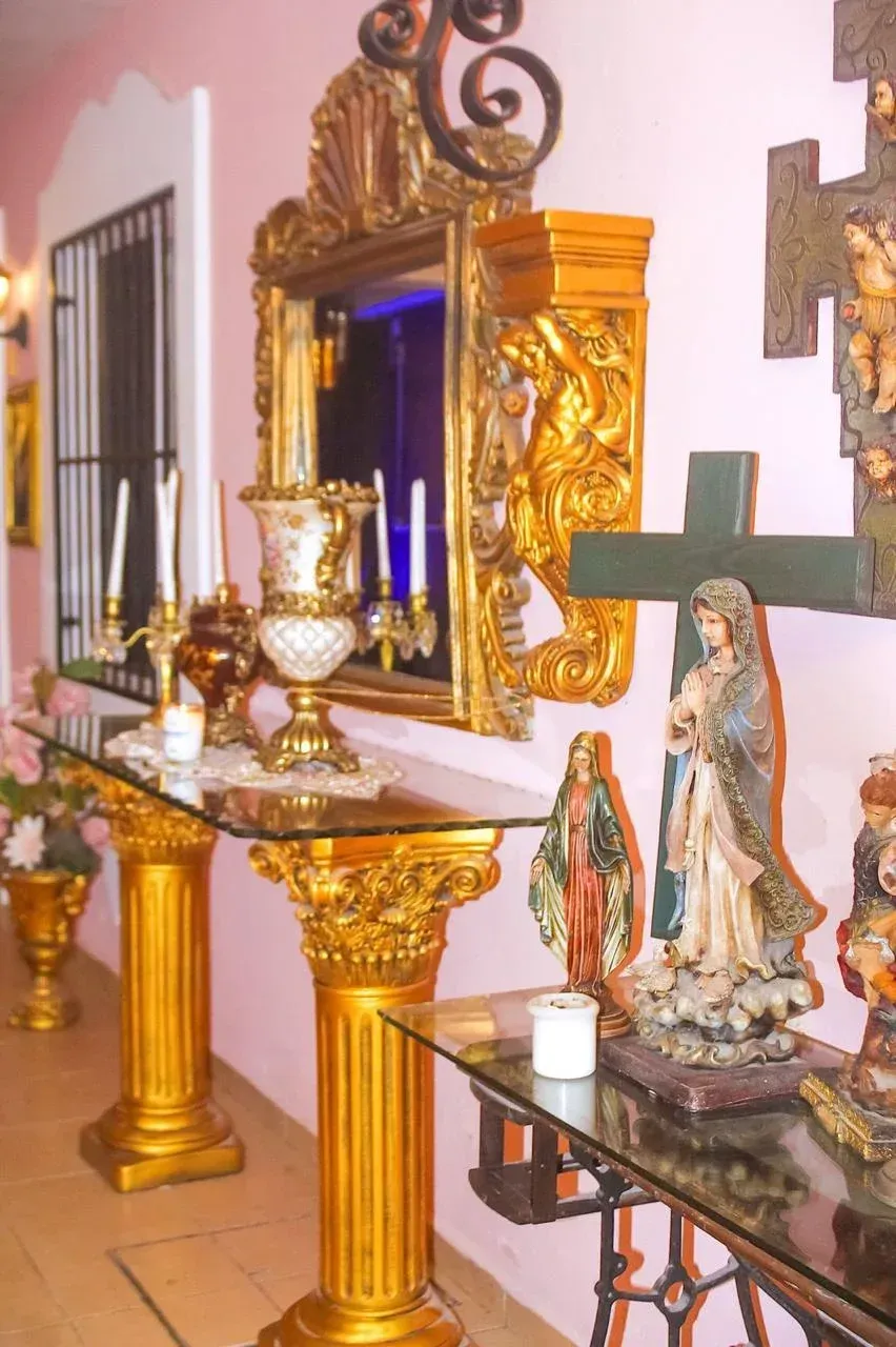 Ornate golden altar with religious statues and candles.