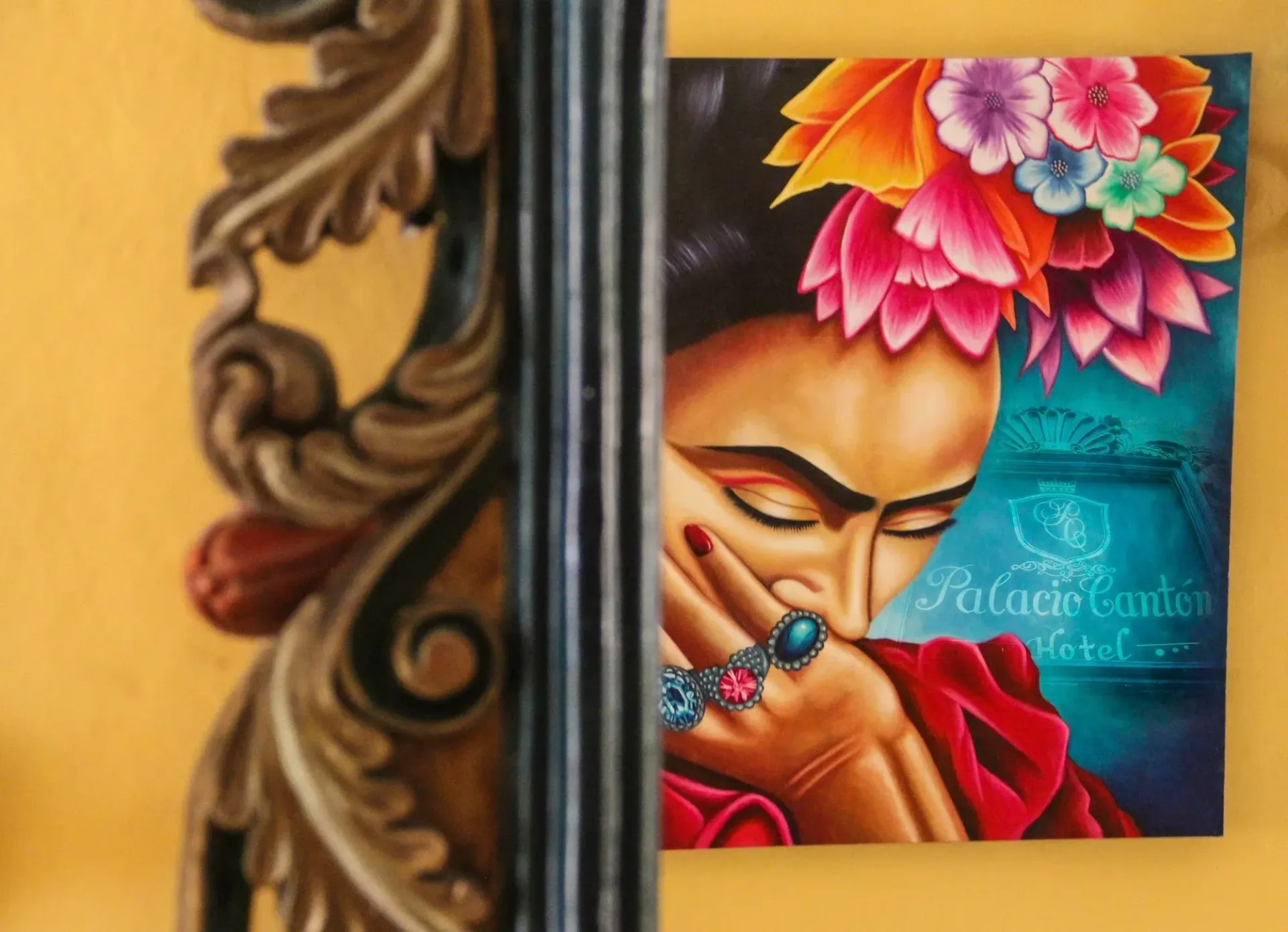 Painting of a woman with a floral headpiece, partially obscured by a decorative pillar.