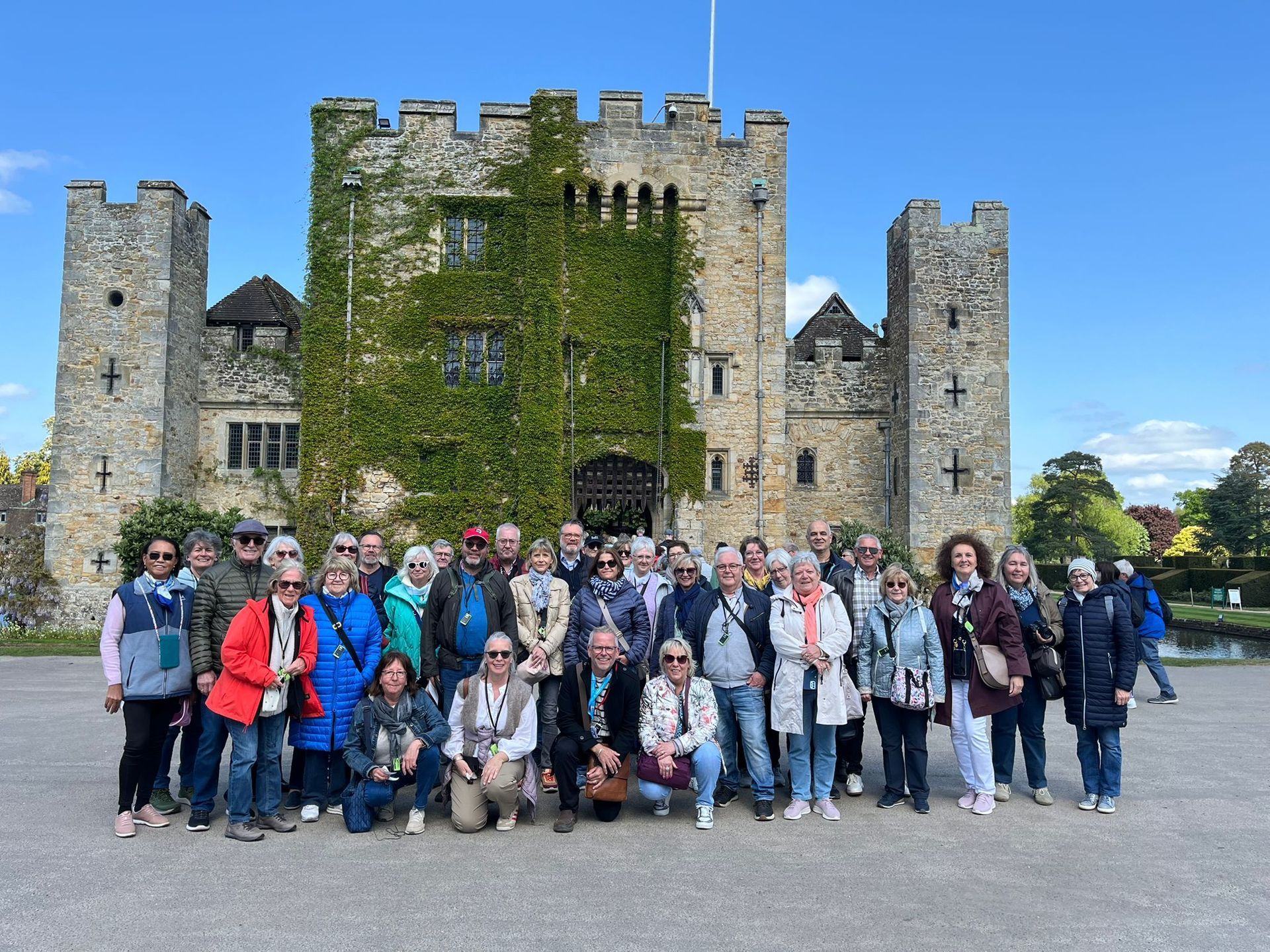 Group of visitors on a guided tour outside Hever Castle, Kent
