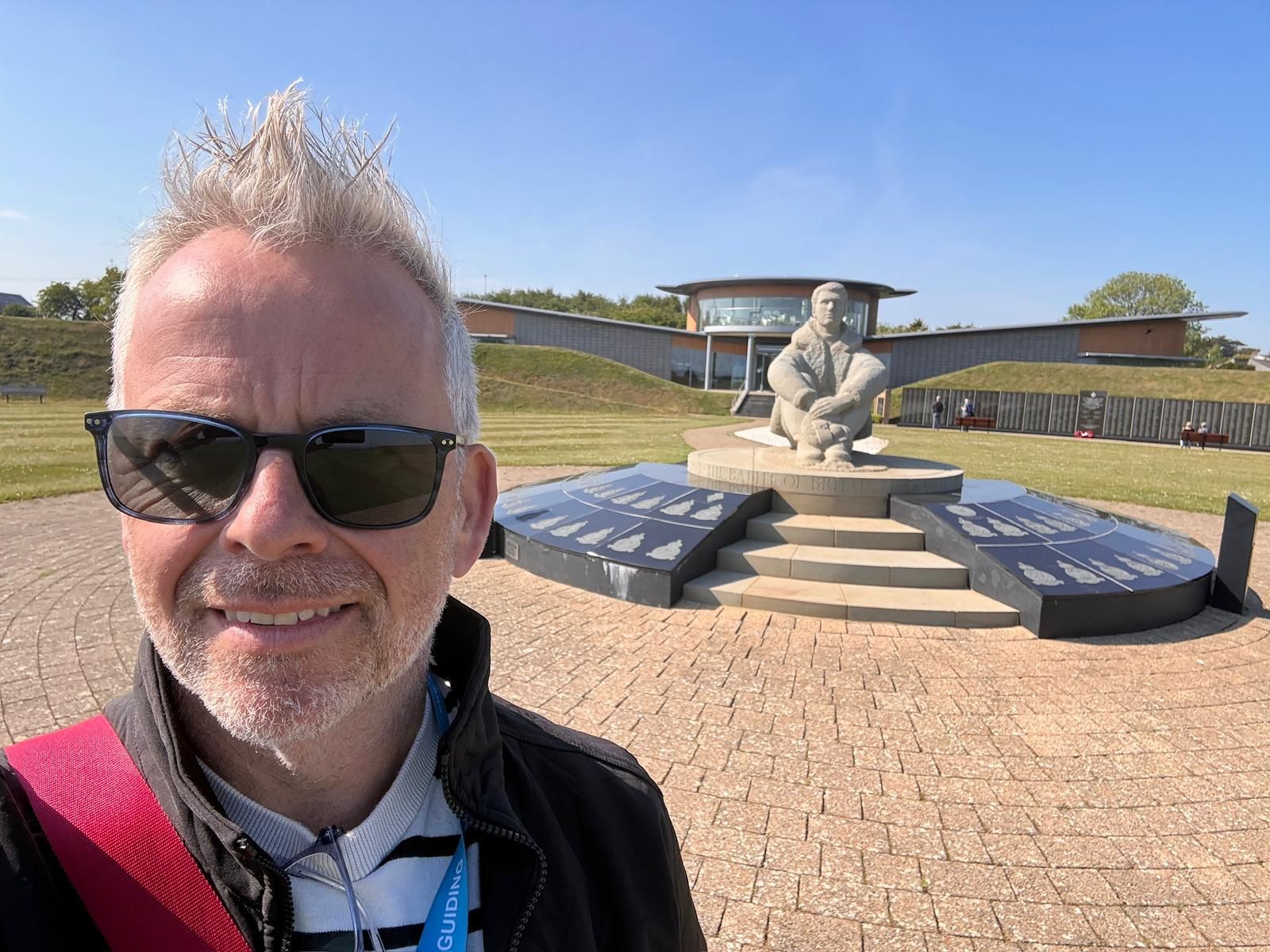 Experienced tour guide Paul standing in front of the Battle of Britain Memorial in Kent.