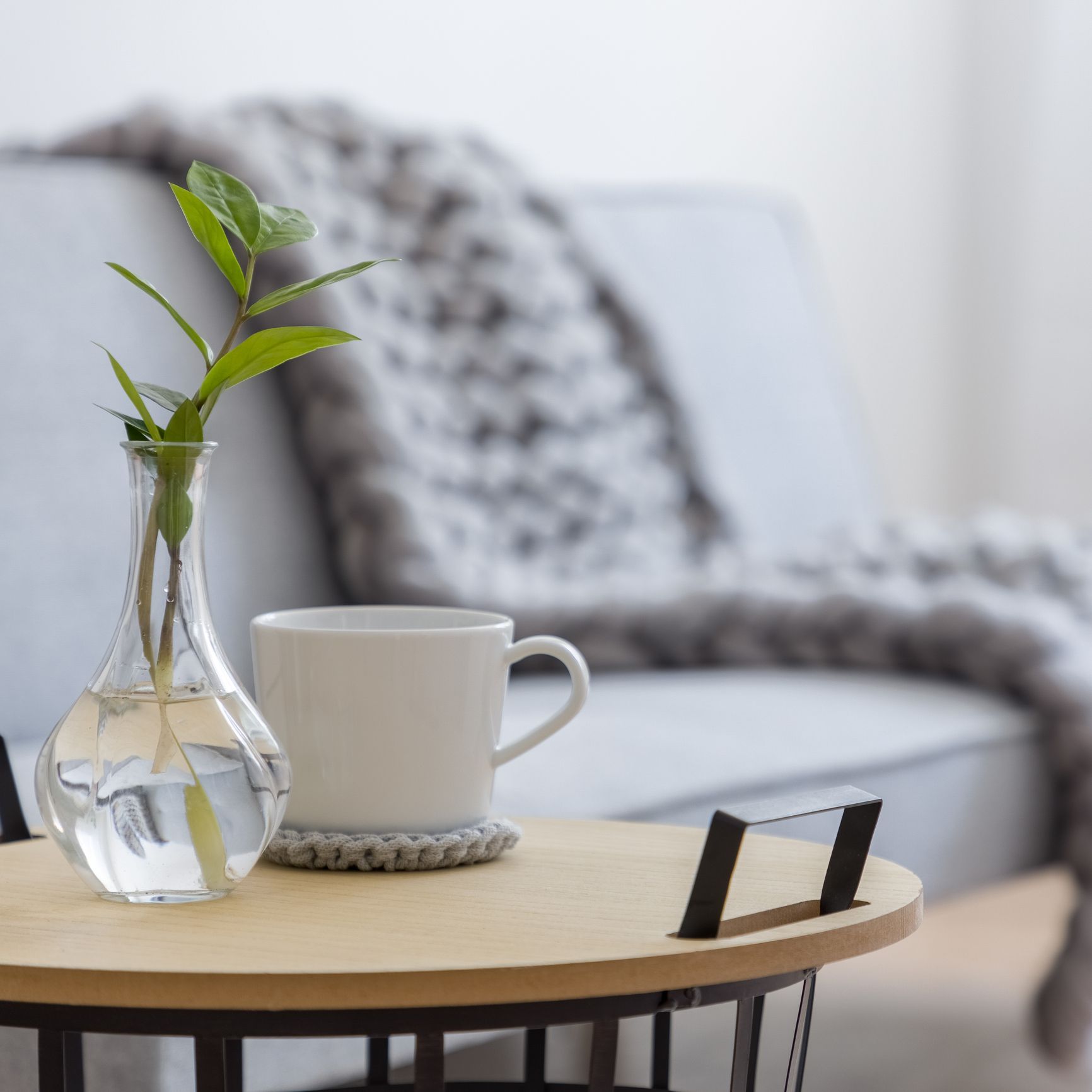 Side table with couch and blanket