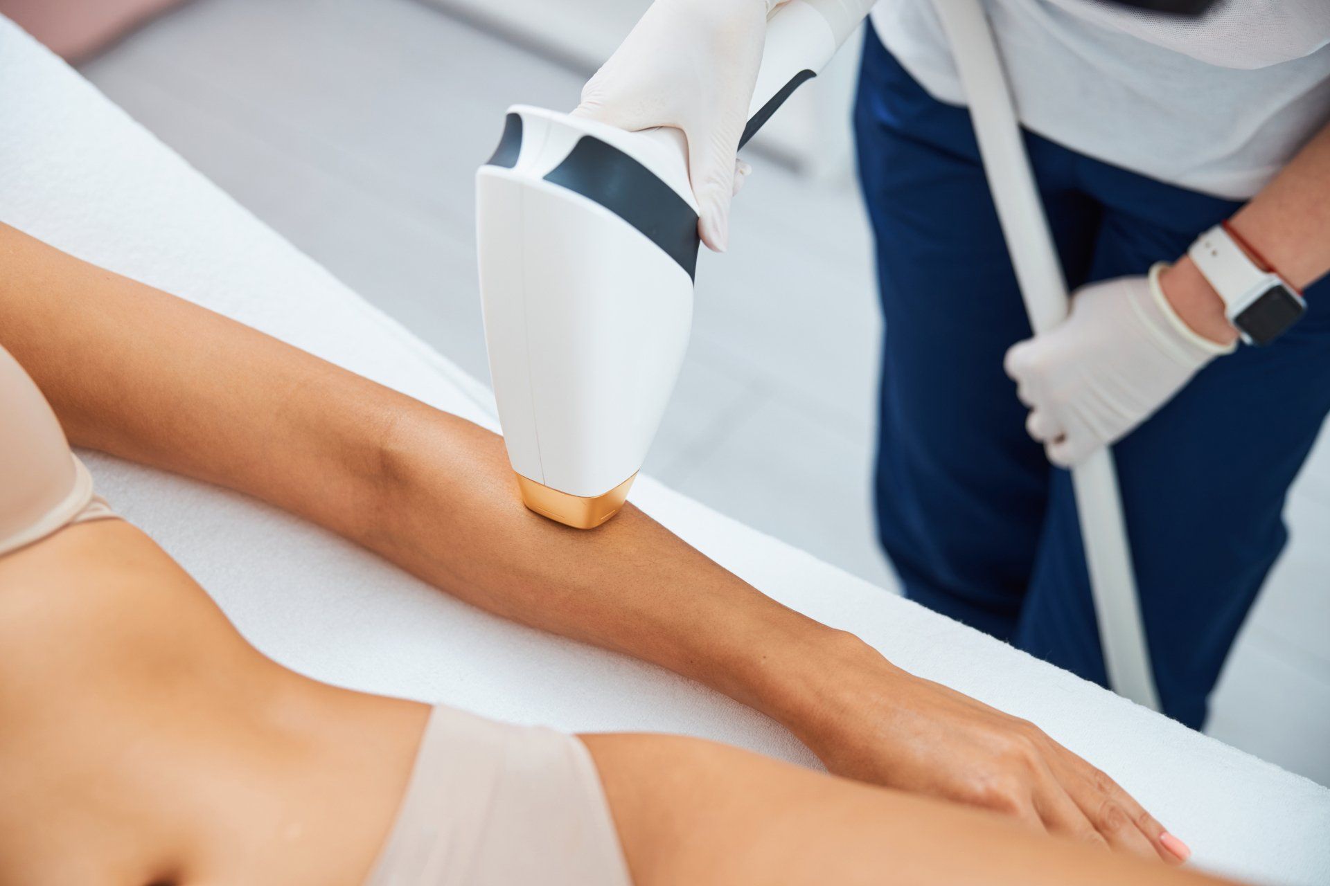 Laser hair removal treatment on a patient’s leg in a clinical setting