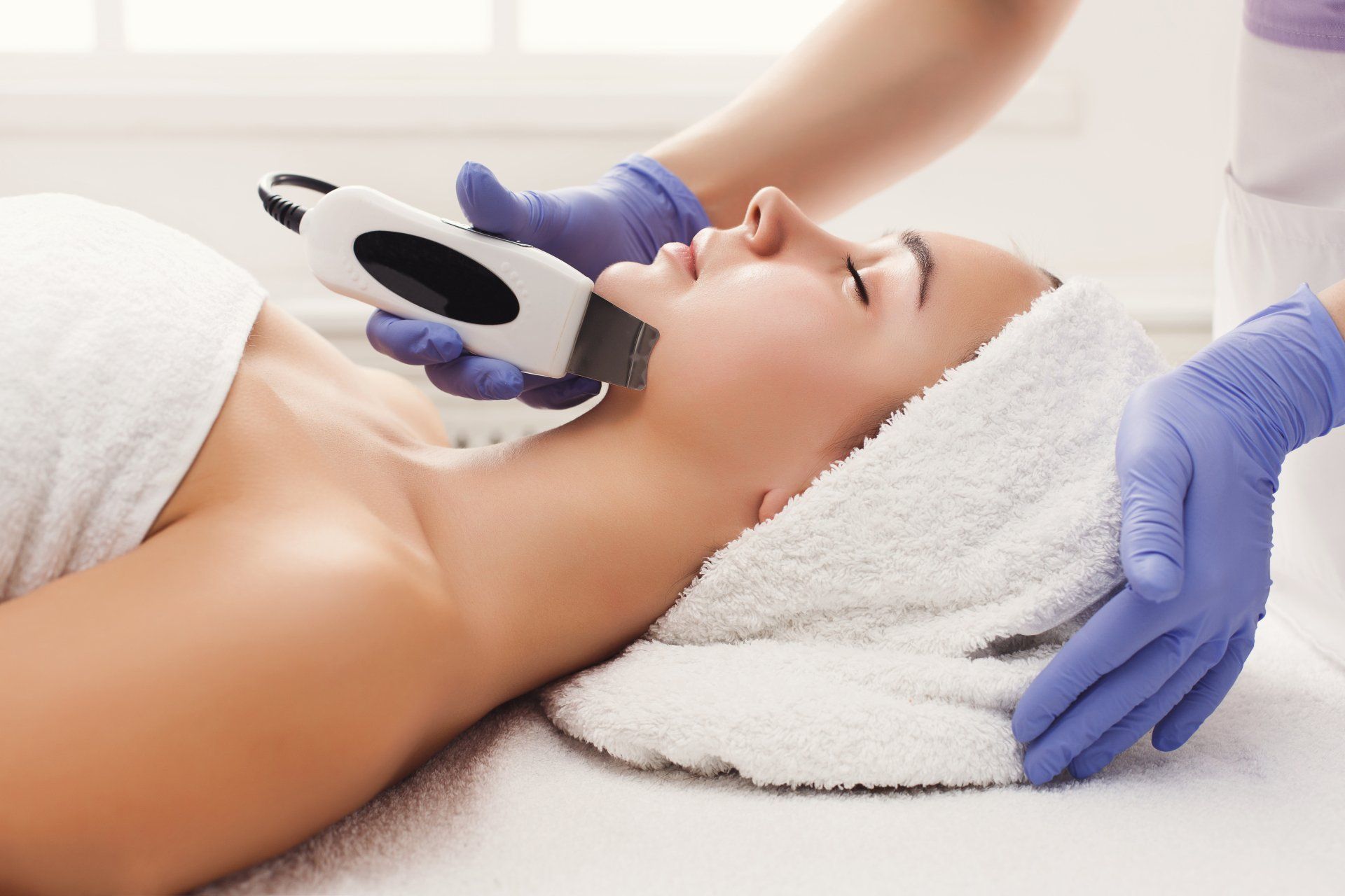 A woman is getting a facial treatment at a spa.