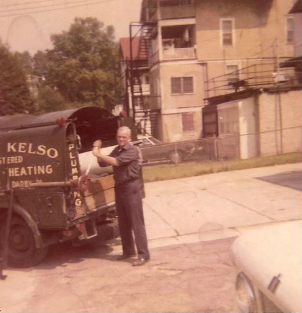 Man unloading from a plumbing truck;