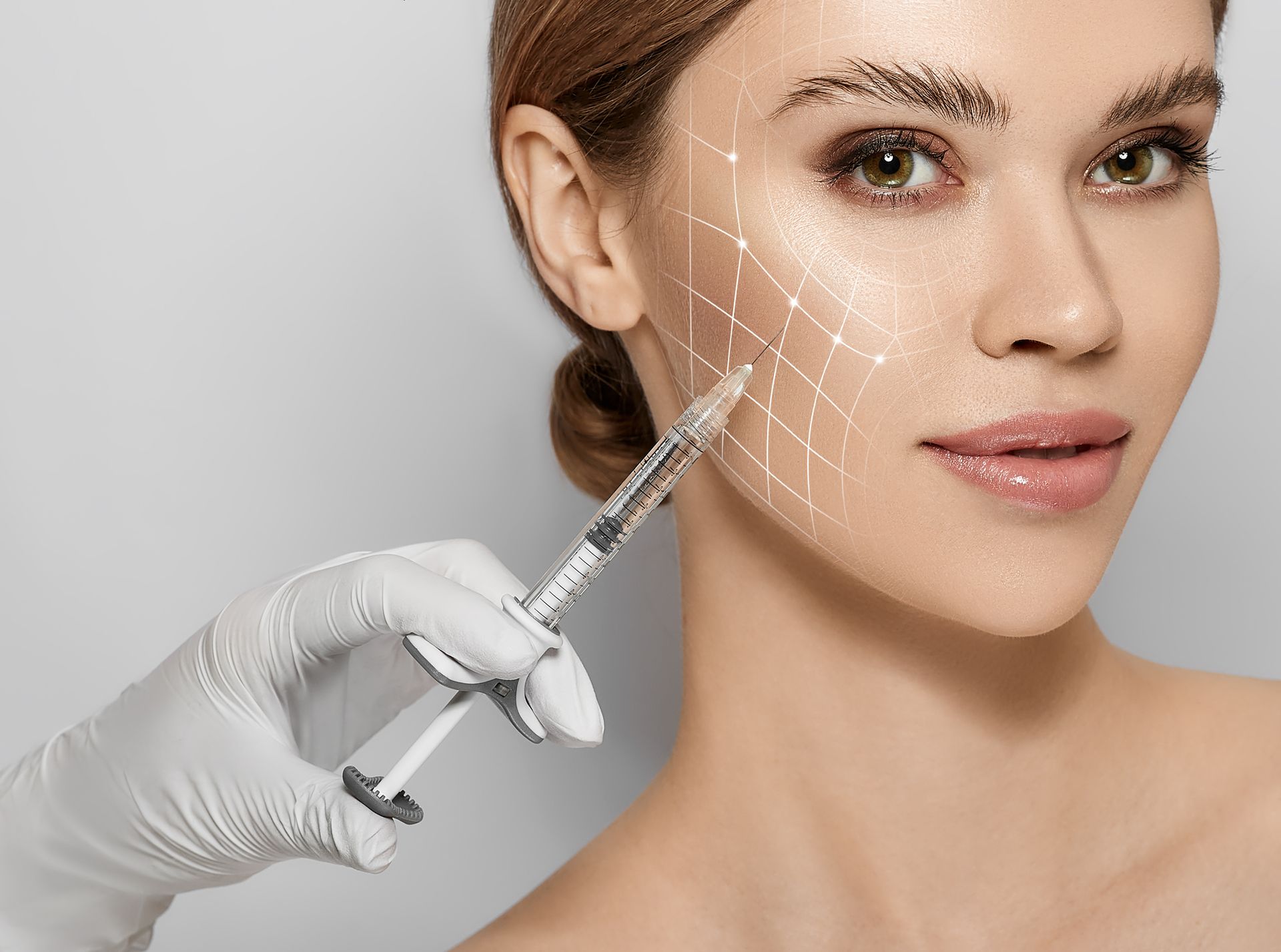 A woman is getting a botox injection in her face. A woman is getting a botox injection in her face.