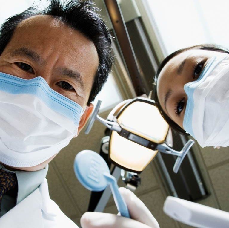A woman is getting her face examined by a doctor wearing gloves. A woman is getting her face examined by a doctor wearing gloves.