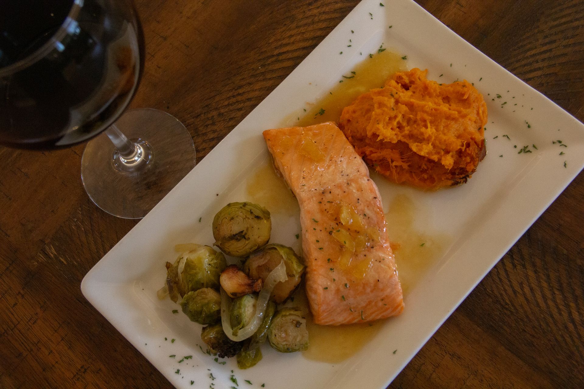 Salmon dinner with Brussels sprouts, sweet potato, and red wine.