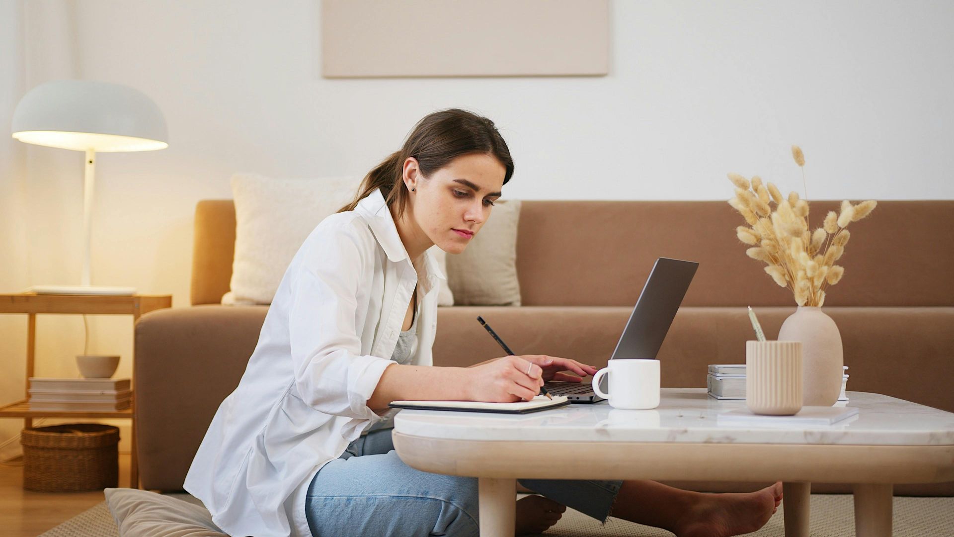 Lady studying on a coffee table