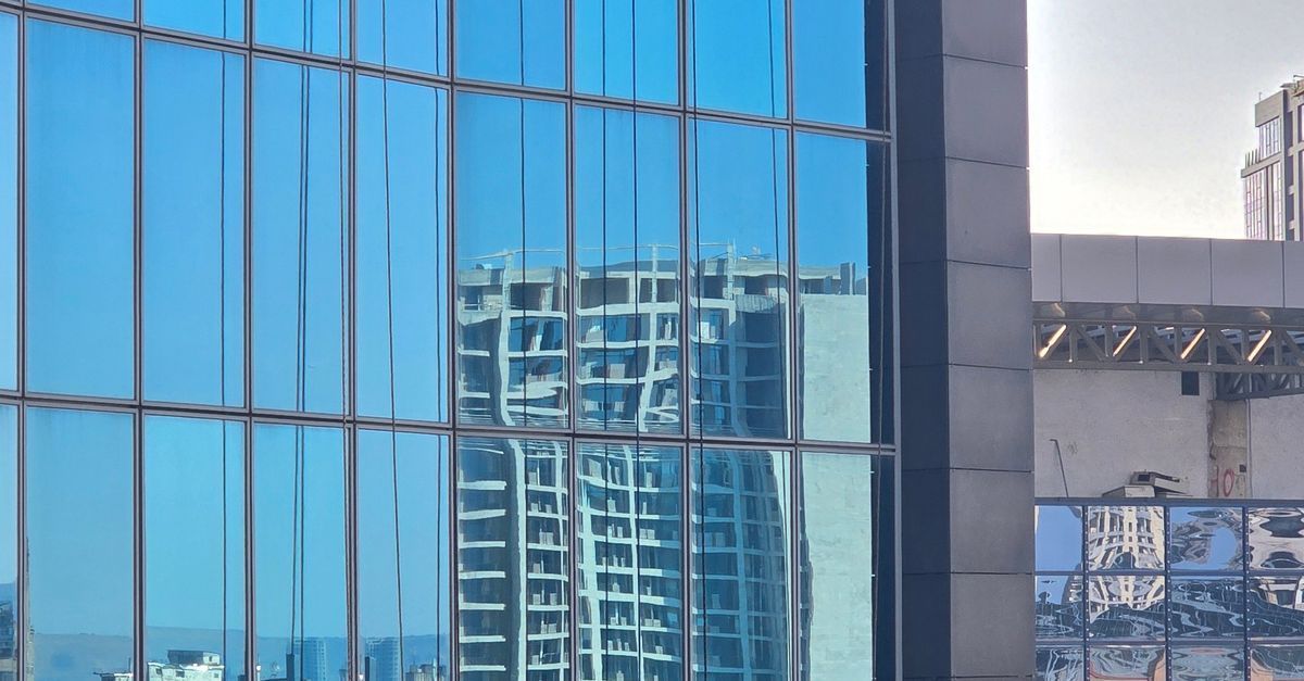 A professional reflecting quietly, representing self-authority in leadership
