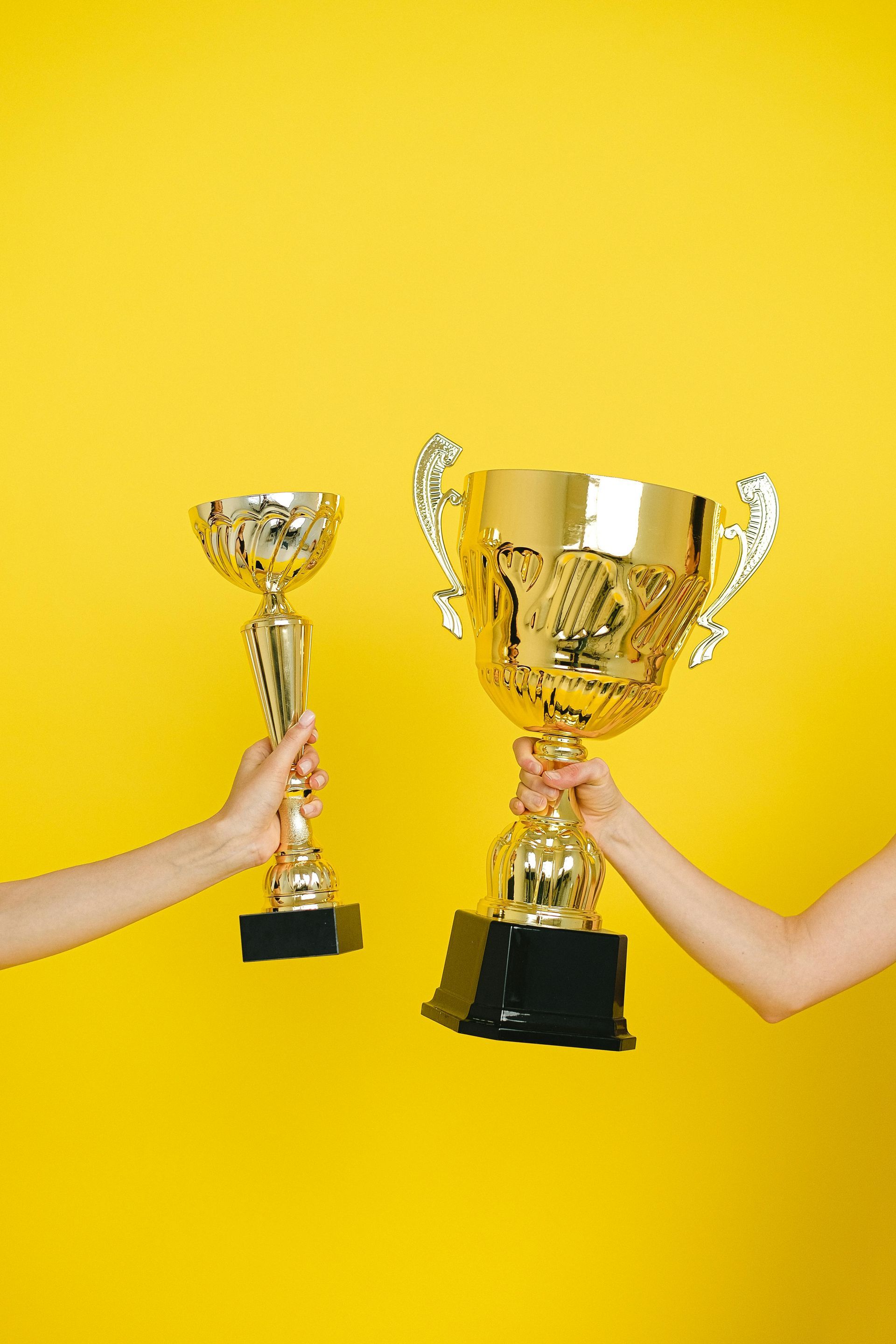 Two trophies are knocking each other.
