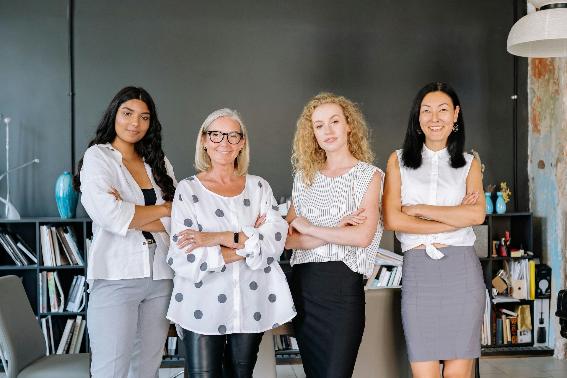Four women smiling confidently