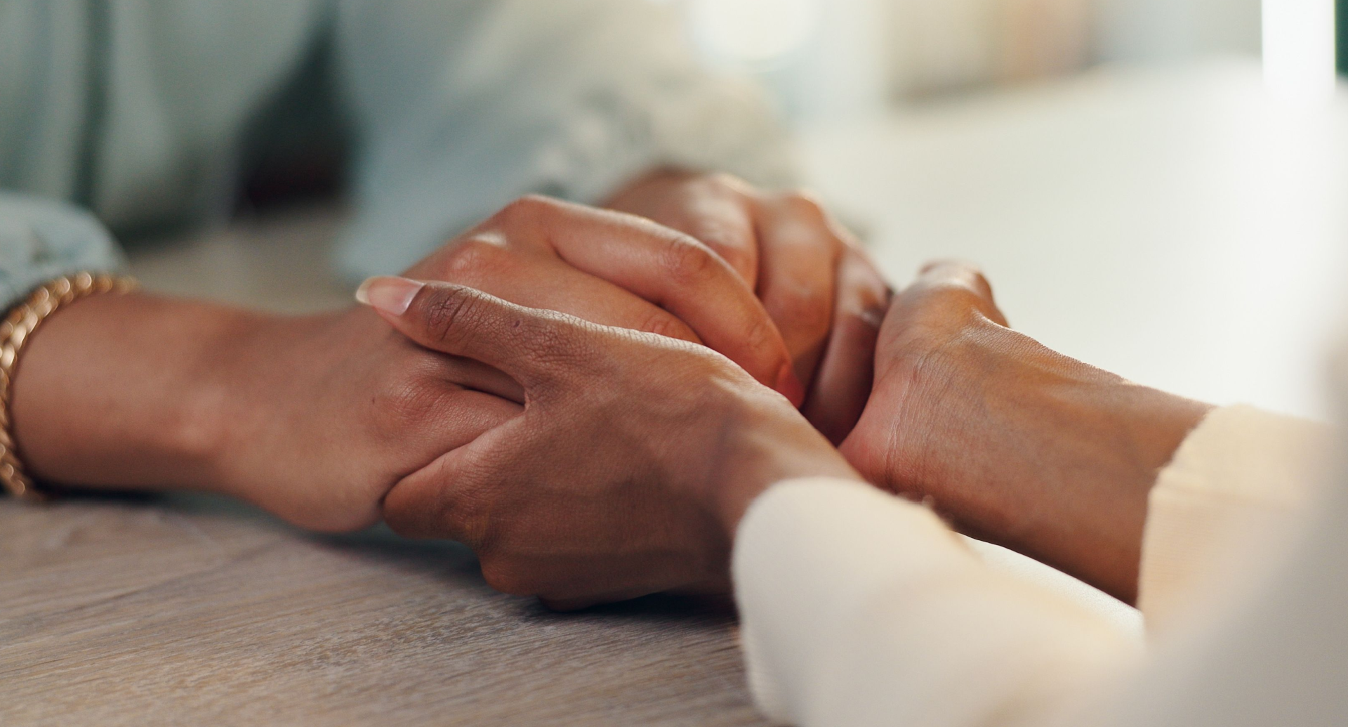 A close up of a person holding another person 's hand.
