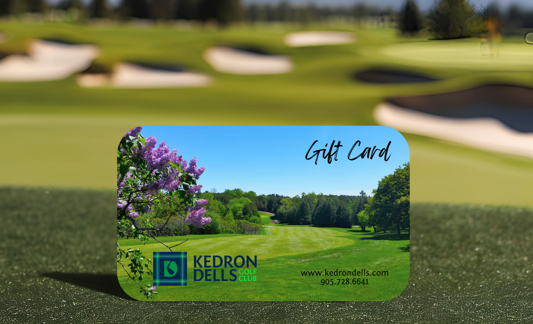 A gift card for kedron dells is sitting on a golf course