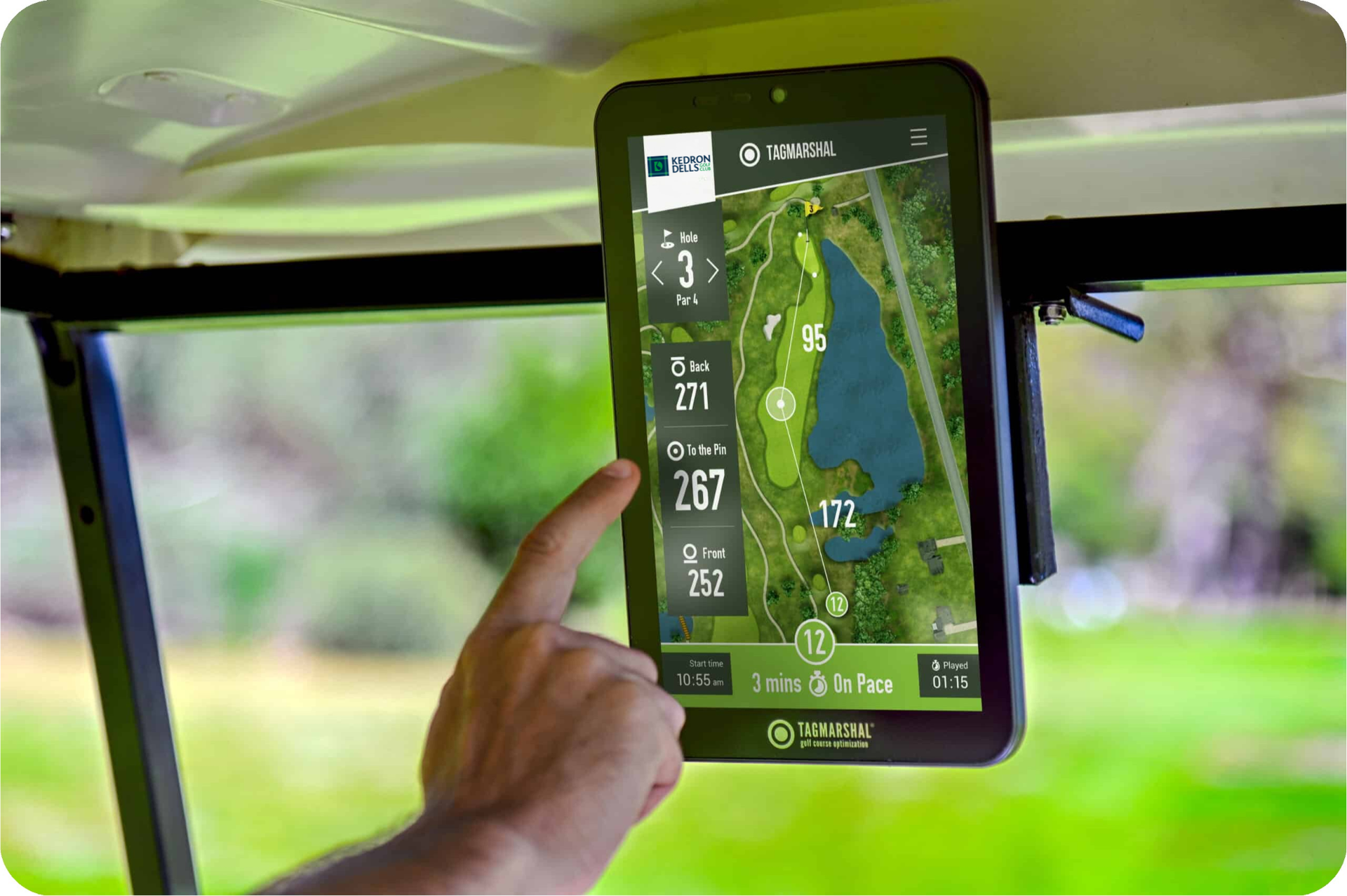 Hand touching a GPS tablet showing a golf course map inside a golf cart