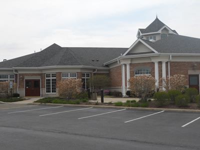 a large brick building with a parking lot in front of it.
