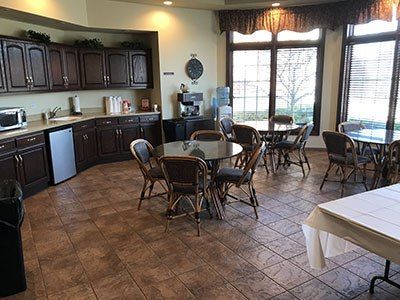 there are many tables and chairs in the room.