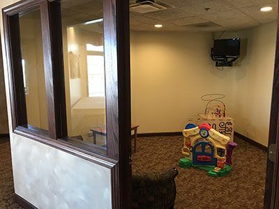 there is a toy house in the middle of the room.