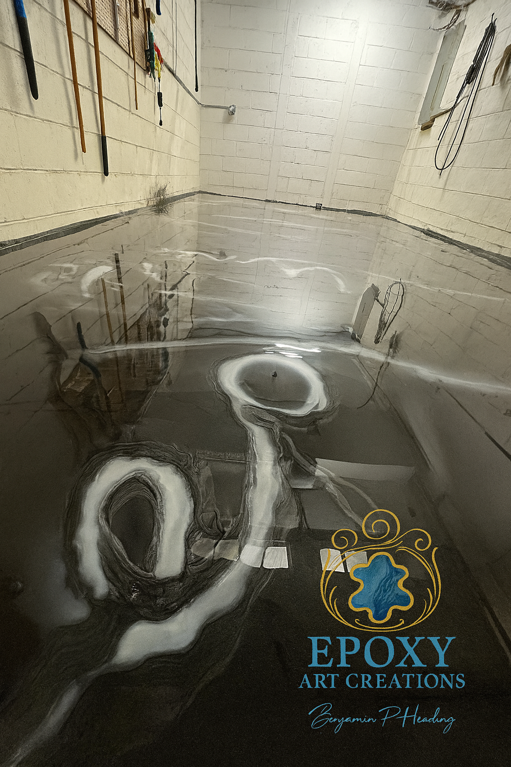 Epoxy floor with white swirling designs, reflective surface, tools and logo visible.