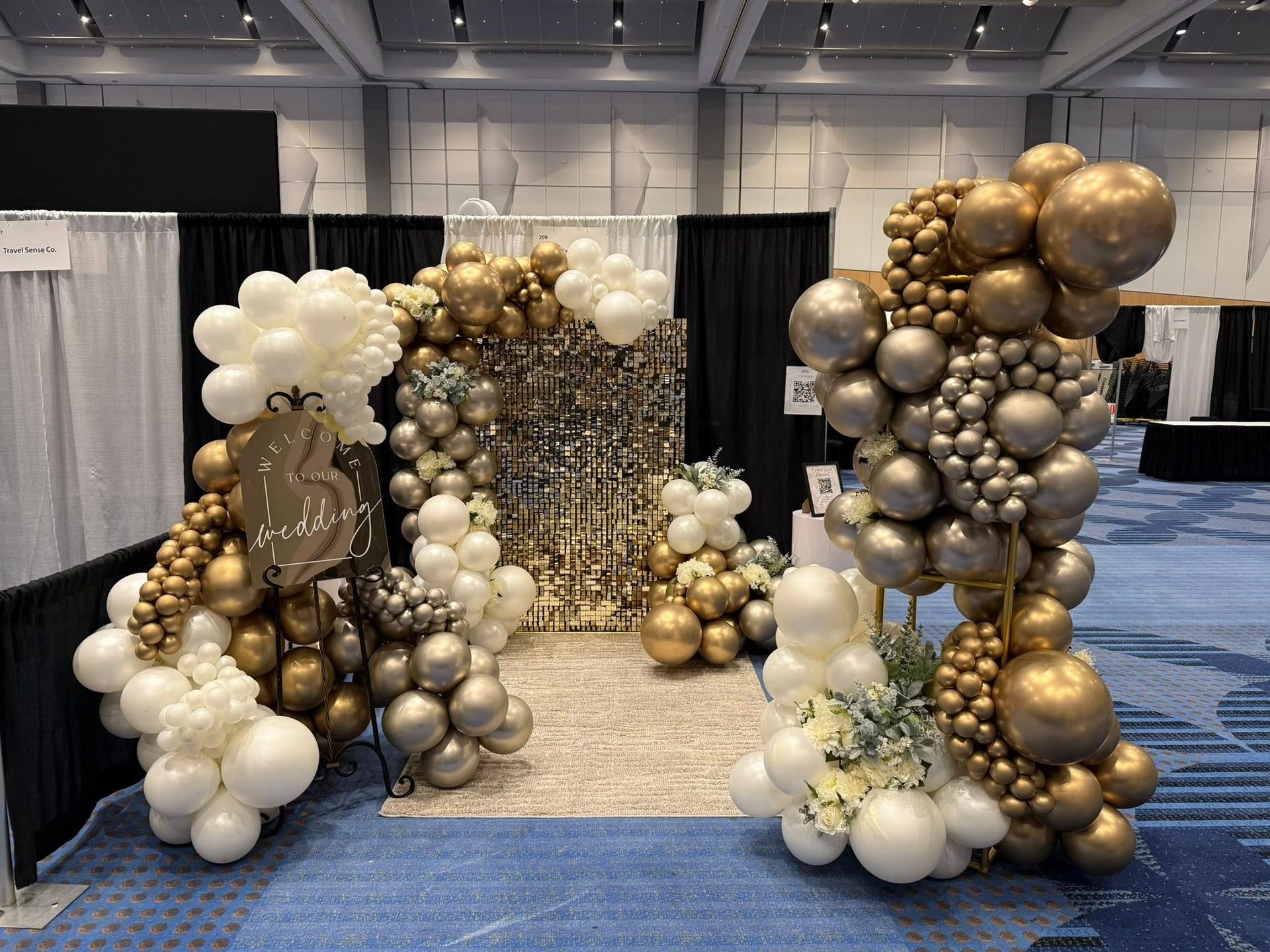 A room filled with lots of balloons and flowers.
