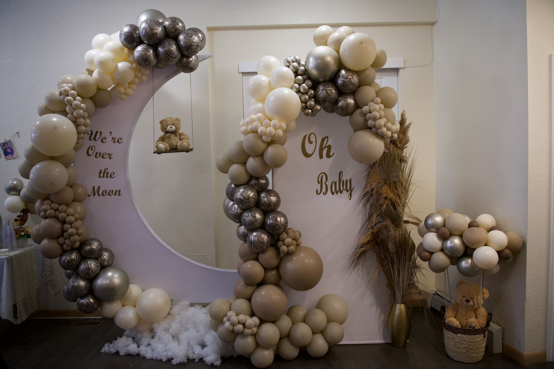 A room decorated with balloons for a baby shower.