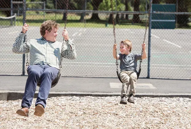 Doctor and child on a swing
