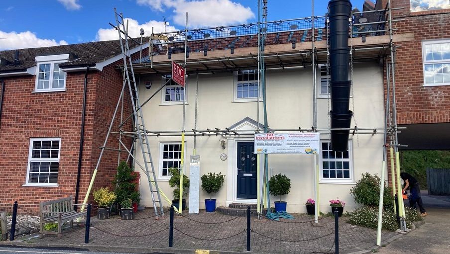 A large brick house with scaffolding on the side of it.