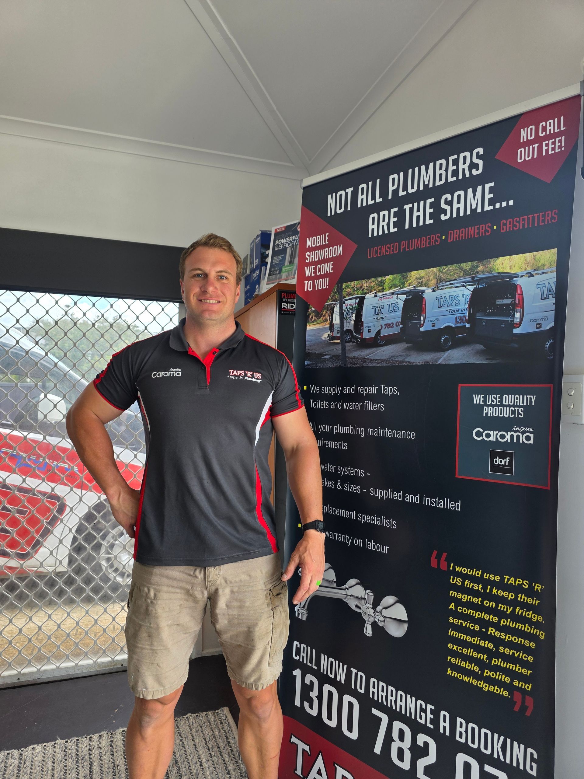 Man standing in a branded tent beside a promotional banner for The Shac. — Taps 'R' Us in Kunda Park, QLD